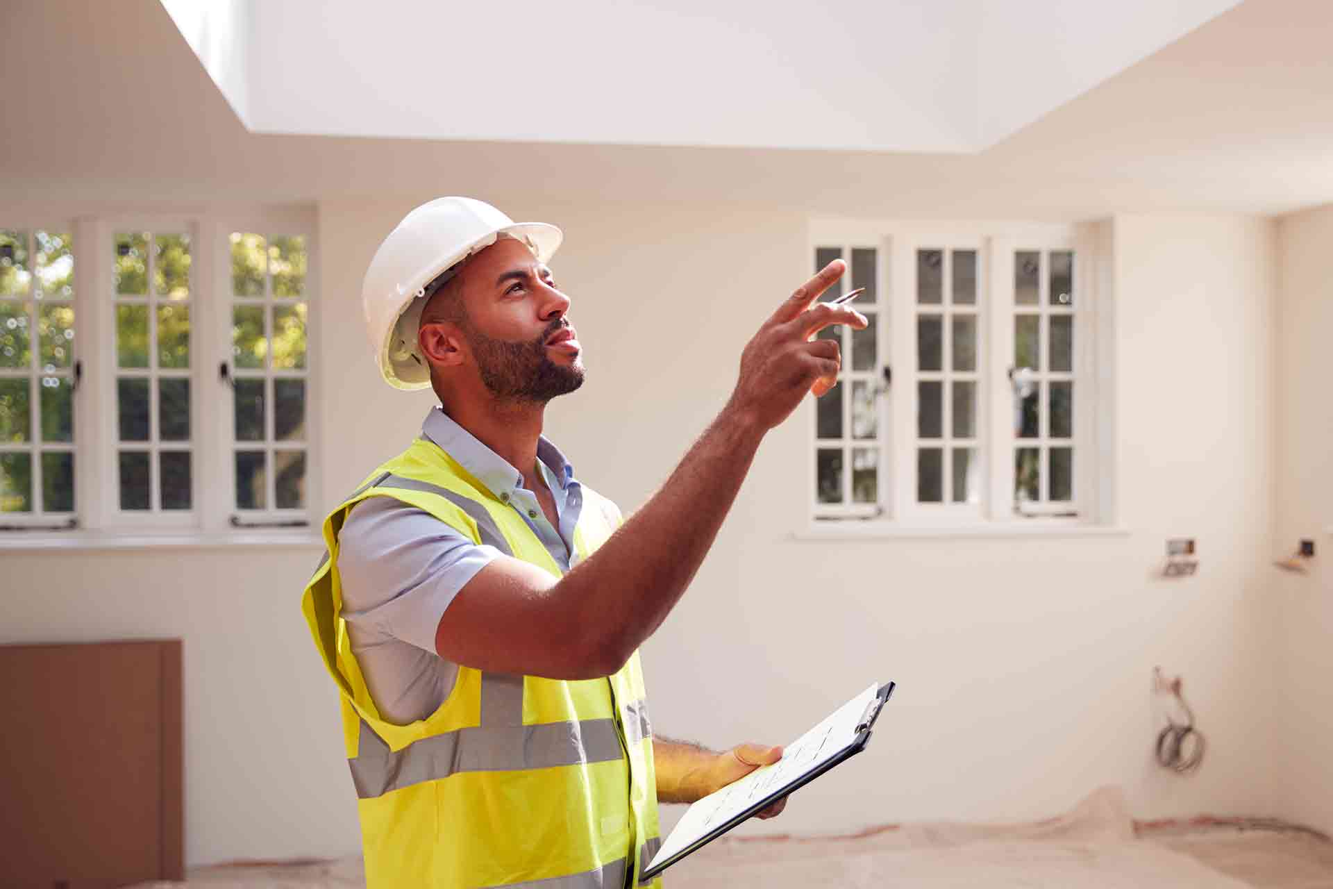 Third Party Wall Surveyors Plymouth reviewing plans between two parties during a dispute